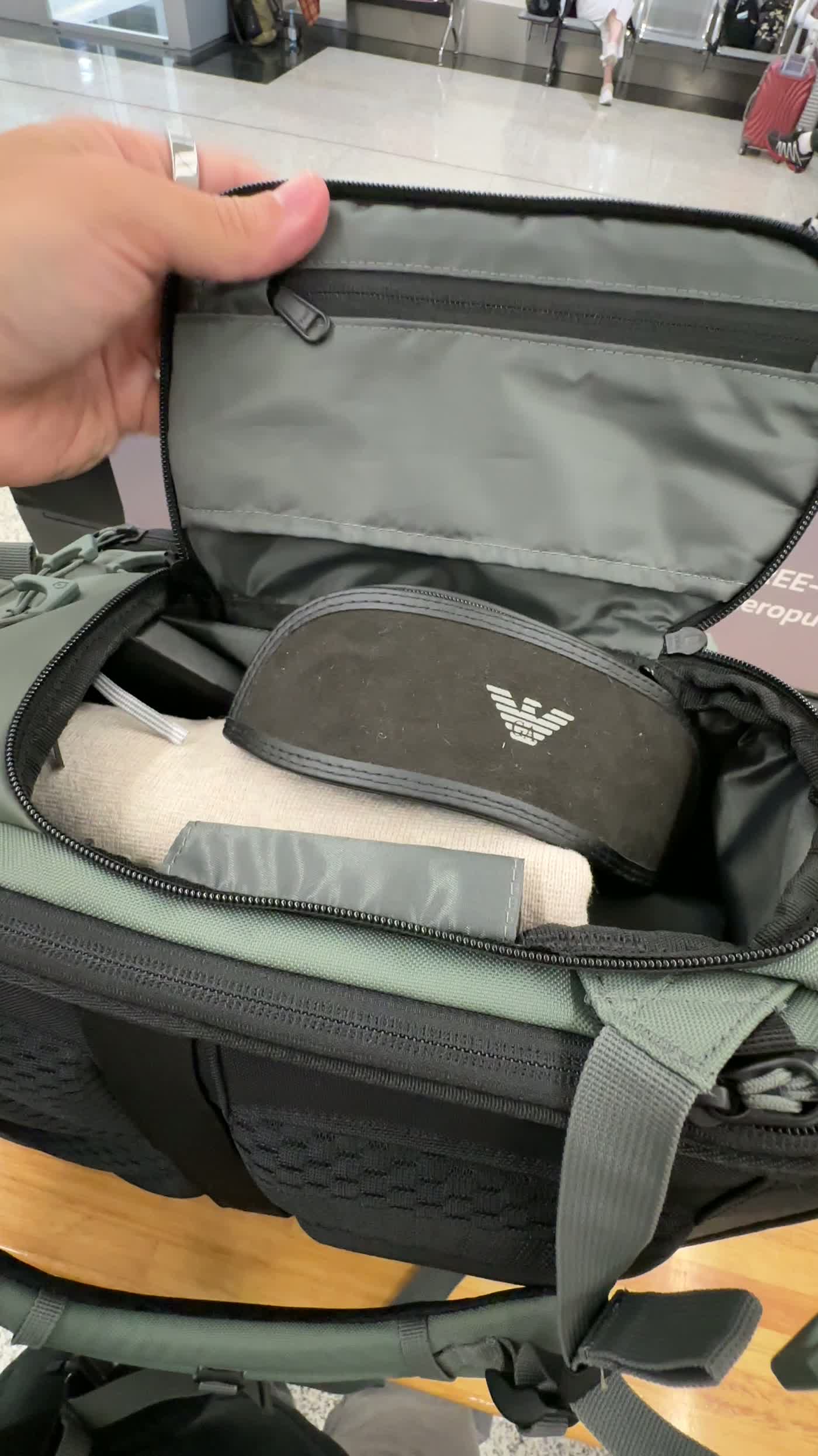 Clamshell opening on the WANDRD PRVKE Pocket 21L showing packed travel gear inside