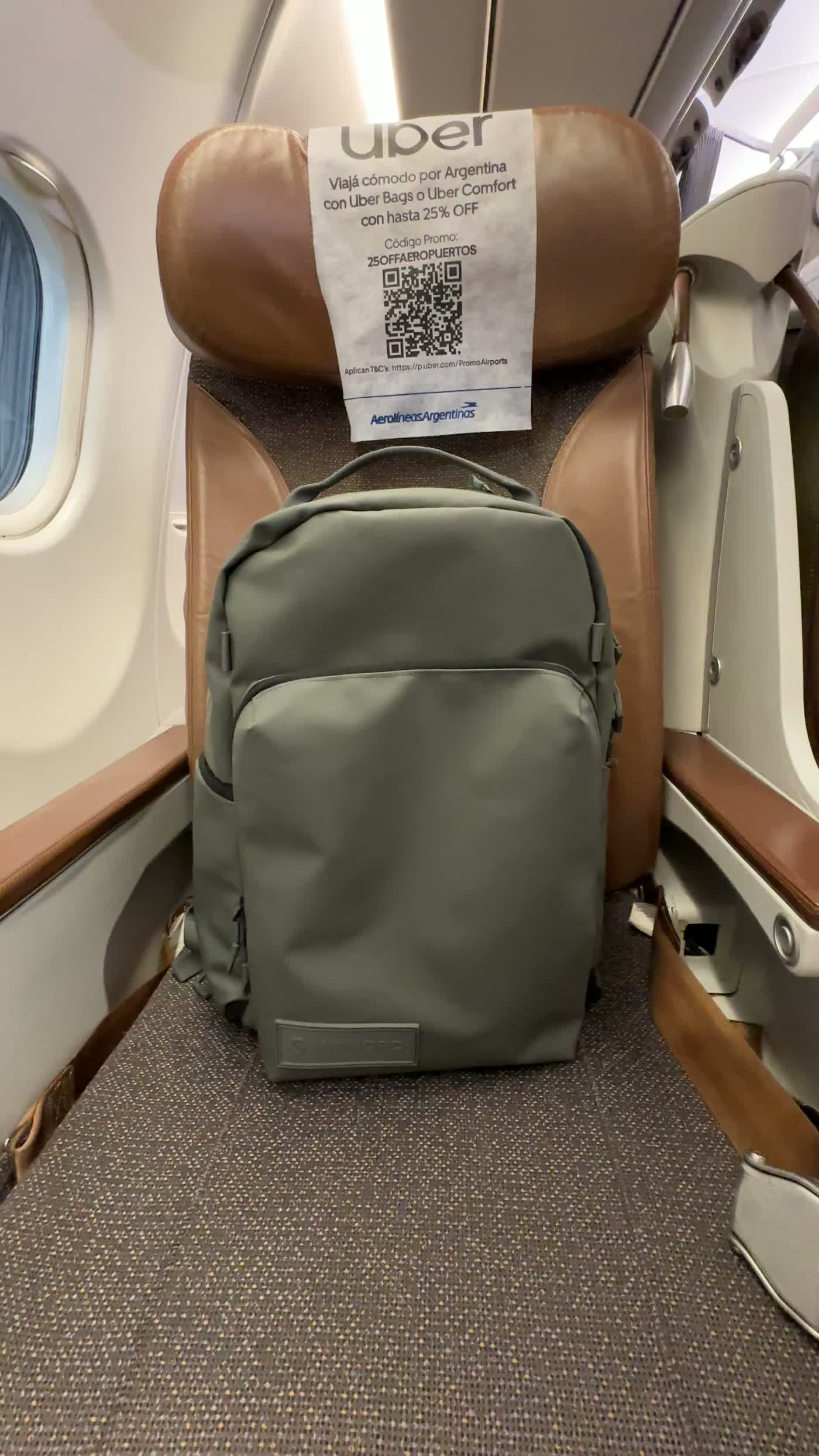 WANDRD PRVKE Pocket 21L placed under an airplane seat during travel